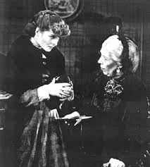 Edna May as Aunt March, doling out some advice to Jo, played by Katherine Hepburn